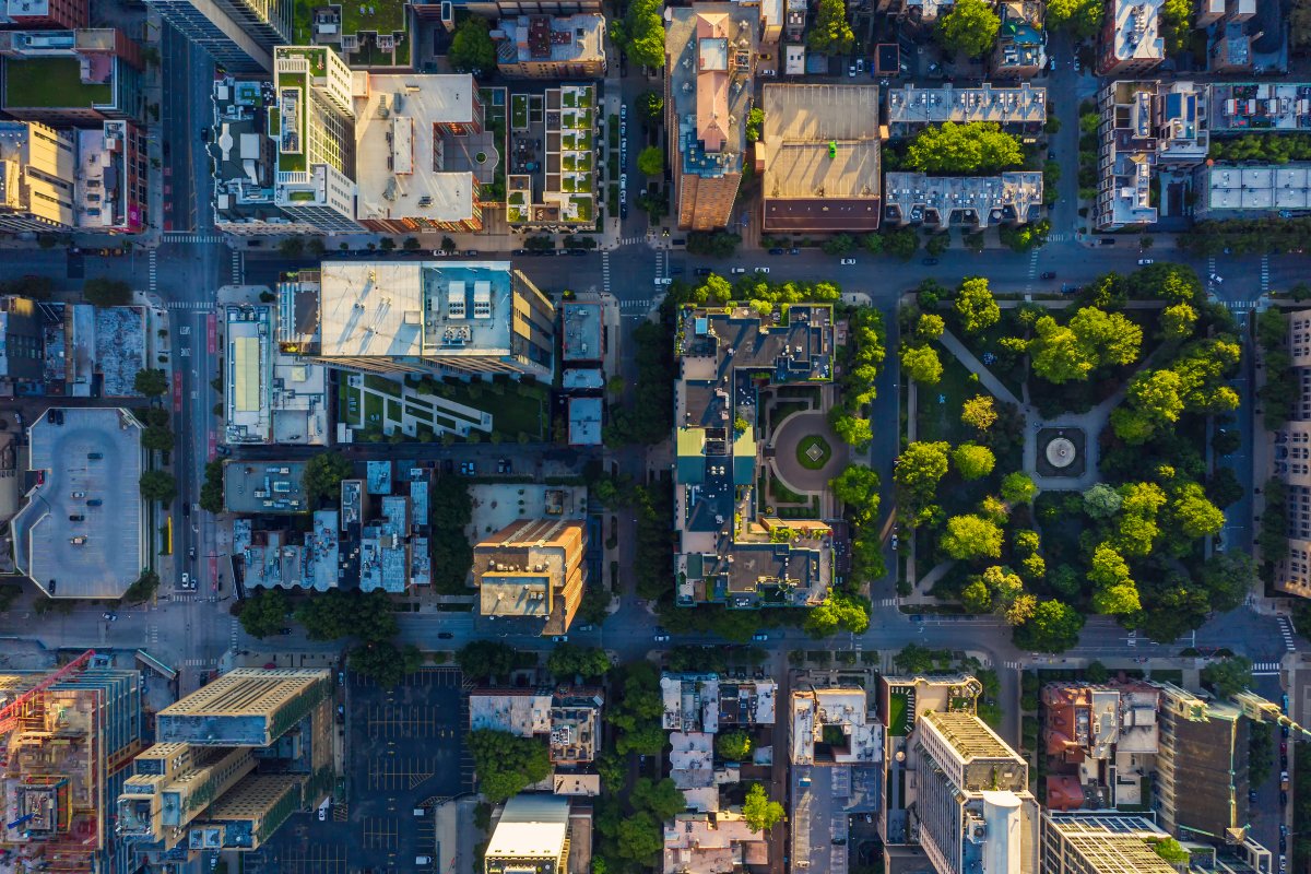 A city from overhead showing skyscrapers, buildings, roads, and parks.