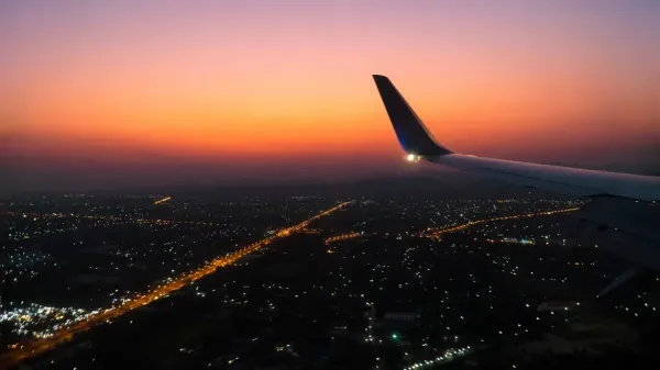 An airplane wing at sunset