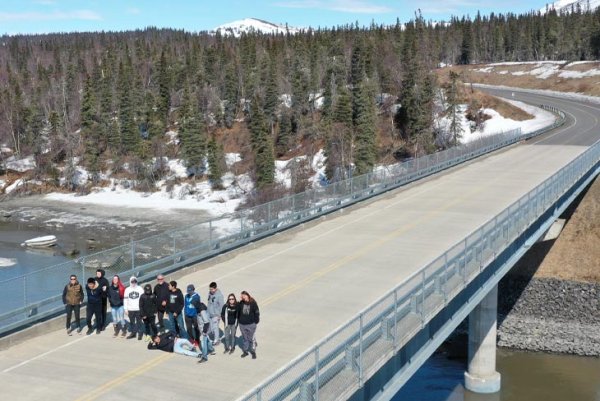 Over the course of two years, Penn State researchers will use drone imagery to assess the effects of Alaska’s harsh climate on the structural condition and safety of the Wood River Bridge, pictured here with students and instructors from the Bristol Bay Regional Career and Technical Education Program. Credit: Steve Colligan/3GLP.