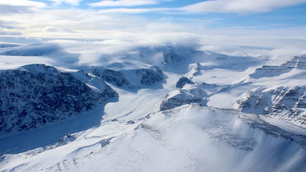 Ice capped and snow-covered mountains of coastal west Greenland.