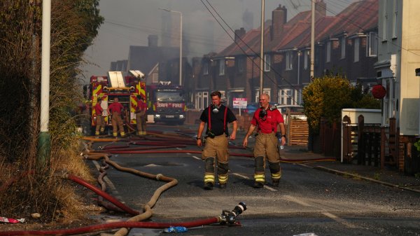 Firefighters in Wennington, a parish near London. The mayor of London said emergency services had battled a dozen major fires on Tuesday. Carl Court/Getty Images