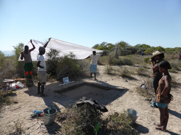 Several MAP team members photographing an excavation trench near the Velondriake Marine Protected Area.