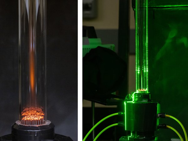 Burning cellulose biomass in a Hencken burner used to determine the ignition properties of solid fuels; a green laser is used to illuminate the particles for particle tracking.