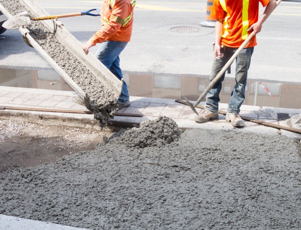 Workers pour concrete at a construction site