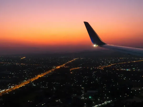 An airplane wing at sunset