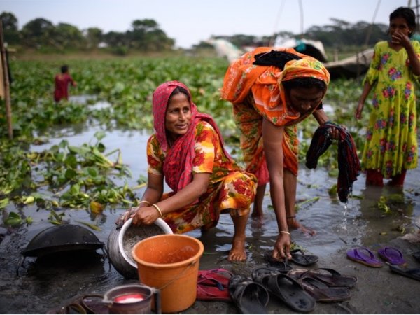 Residents of Matlab, Bangladesh, performing daily water-related tasks. Photo credit: Kriston Jae Bethel Photography
