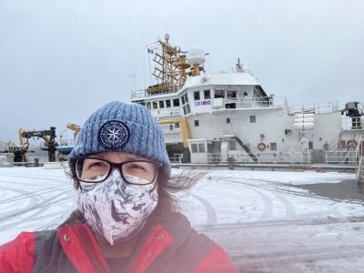 Laura Guertin Alaska standing in front of NOAA Ship Oscar Dyson