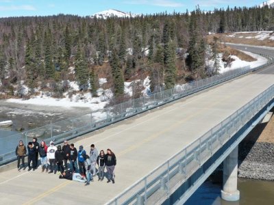 Over the course of two years, Penn State researchers will use drone imagery to assess the effects of Alaska’s harsh climate on the structural condition and safety of the Wood River Bridge, pictured here with students and instructors from the Bristol Bay Regional Career and Technical Education Program. Credit: Steve Colligan/3GLP.