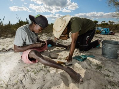 Two MAP team members closely examine artifacts coming out of a test pit in the Namonte region of Southwestern Madagascar. (photo credit: Garth Cripps)