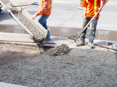 Workers pour concrete at a construction site