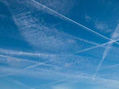 Pattern of several aircraft contrails in the blue sky